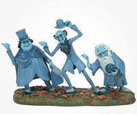 Front view of blue three-ghost statue on grass base