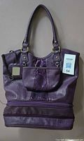Front view of purple travel tote with cosmetic pouch and mirror