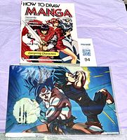 Front view showing How to Draw Manga Volume 1 book and sealed Dragon Ball Super clear file folder