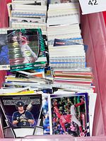 Stacked bins of assorted baseball cards showing variety including foil insert