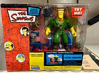 Front view of sealed McBain figure in original Simpsons Aztec Theater packaging