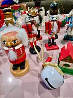 Group showing nutcrackers, jingle bell, house ornament