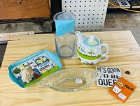 All items grouped on tabletop: teapot, matching tray, vase, glass dish, magnets, figurine
