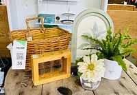 All items grouped: wicker basket, bud-vase block, two faux plants, oval botanical print