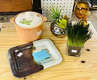 Group shot showing crock with lid, pottery tray, two faux plant arrangements, and two amber glass goblets