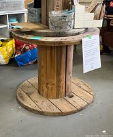 Full view of wooden cable spool showing top, core slats and base