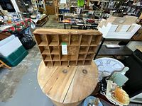 Front view of wooden cubby shelf on table