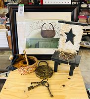 Group shot showing framed print, stool, basket, padlock with keys, twig wreath