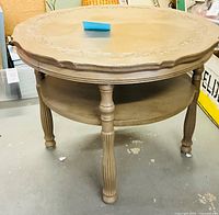 full view of round table showing legs and lower shelf