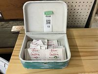 Open wooden suitcase showing contents of holiday wish bracelets