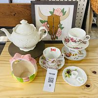 All items grouped: teapot, teacups, saucers, miniature tea set, candle holder