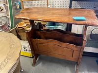 Front and side view of wooden side table with magazine holder