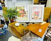 Overall lot showing framed prints, shelf brackets, wall hook board and artificial plant