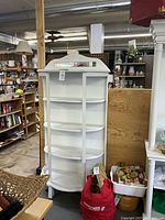 Front view of white chalk-painted curio cabinet with five open shelves