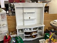 Full front view of white display cabinet showing upper and lower shelving