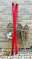 All items: red wooden skis, three wooden snowshoes, pair white skates