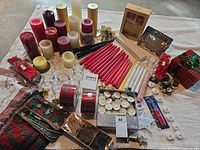 Overview showing candles, tealights, ribbons, votive holders and décor pieces