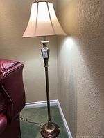 Full view of bronze floor lamp with ivory shade