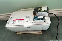 HP DeskJet 2655 printer with three HP 65 ink cartridge boxes on top