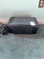 Front and top view of HP Deskjet F4435 printer with cables