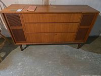 Front view of Dynatron stereo console showing cabinet and speaker grilles