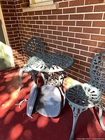 Table and chairs set with cushions displayed