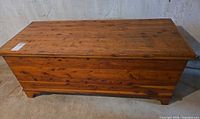 Front perspective of cedar chest showing overall design and feet