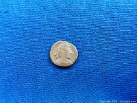 Obverse side showing worn bust profile