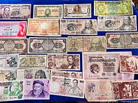 Overview of all banknotes laid out on blue surface