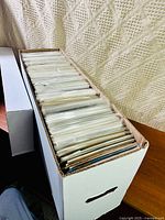 Long white comic storage box filled with bagged comics