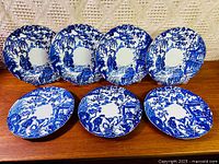 All seven Royal Crown Derby Mikado plates displayed upright and flat