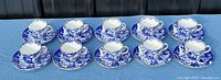 Ten Royal Crown Derby Mikado cup and saucer sets laid out