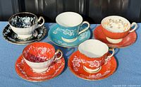 Five teacup and saucer sets front view
