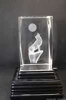 Front view of illuminated crystal on base