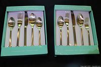 Two unopened 20-piece flatware sets in boxes