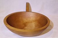 Overall view of wooden serving dish showing handle and interior