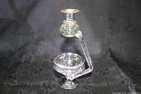 Full view of glass essential oil diffuser showing reservoir, arm, and candle holder