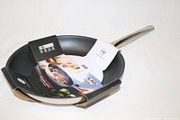 Top view of Kuhn Rikon frying pan with packaging insert showing product details
