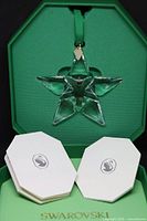 Ornament in open box with booklets visible