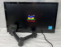 Front view of ViewSonic monitor displaying logo with attached wall mount arm