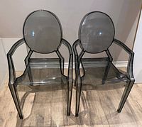 pair of smoke grey acrylic armchairs front view