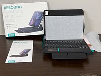 Box, manual, keyboard case on stand