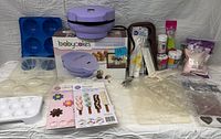 Lot overview with cake pop maker, molds, stand, sticks and decorations