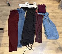 Full layout showing pants row, overalls, tee stack and swimsuit top