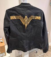 Back view showing gold Wonder Woman logo and seam details