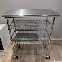 Front view showing stainless top, basket, shelves, casters