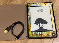 Kindle in decorative case with USB cable