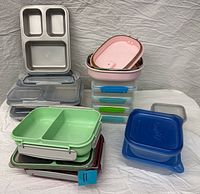Mixed stack of lunch containers and food storage boxes displayed