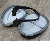 Muse 2 headband resting on open gray zippered case