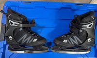 Pair of K2 F.I.T. Ice skates side view on blue bin